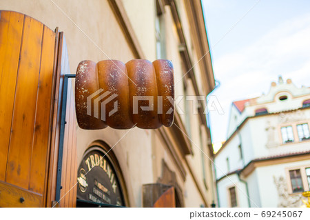 Trdelnik shop of traditional Czech pastries, advertising sign on the facade of the building 69245067