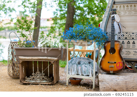 Summer cafe in a green park. Themed hipster cafe in the city park. Decor items 69245115