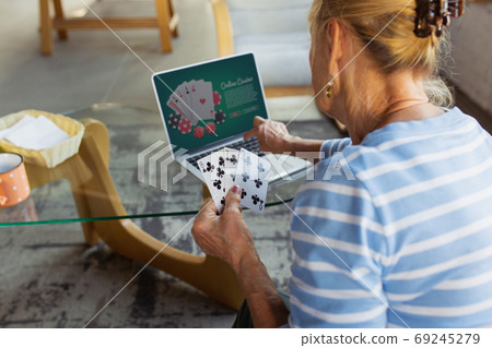 Senior woman studying at home, getting online courses Senior woman studying at home, getting online courses 69245279