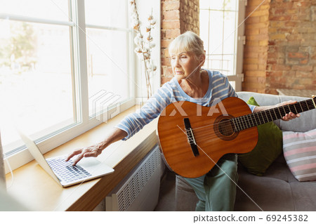 Senior woman studying at home, getting online courses 69245382