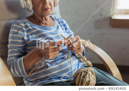 Senior woman studying at home, getting online courses Senior woman studying at home, getting online courses 69245408