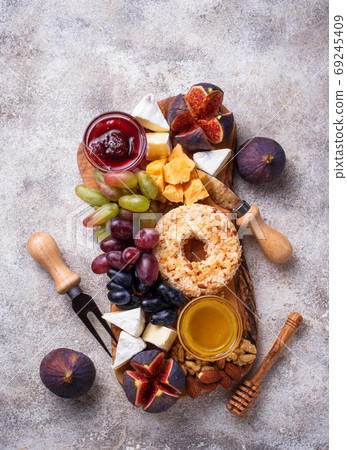 Appetizer for wine, cheese plate with grapes and figs Appetizer for wine, cheese plate with grapes and figs 69245409
