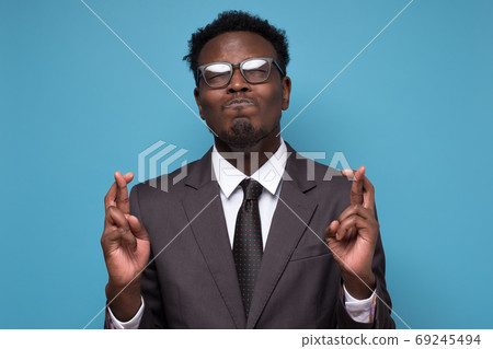 African young businessman making a wish crossing fingers 69245494