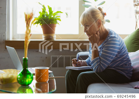 Senior woman studying at home, getting online courses 69245496