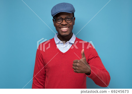 african man with cheerful facial emotion showing thumb up 69245673