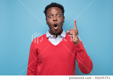 Surprised african man pointing up finger giving advice 69245751