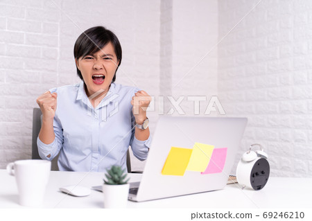 Angry woman working at office 69246210