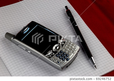 Vintage Mobile Phone with Pencil on Squared Paper 69246752