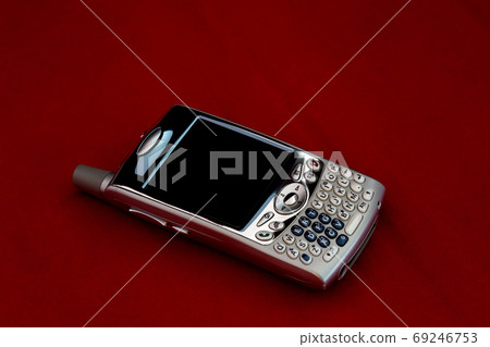 Vintage Mobile Phone on a Red Background Vintage Mobile Phone on a Red Background 69246753