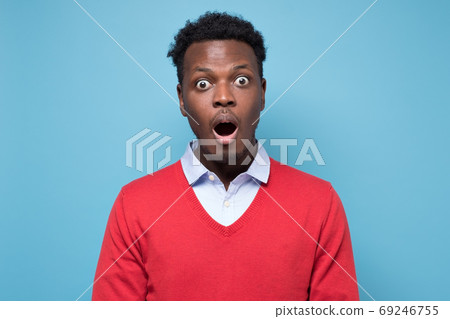 Handsome african man looking in shock and frustration at the camera Handsome african man looking in shock and frustration at the camera 69246755