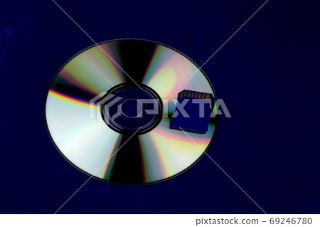 Compact Disc with Memory Card on a Blue Background Compact Disc with Memory Card on a Blue Background 69246780