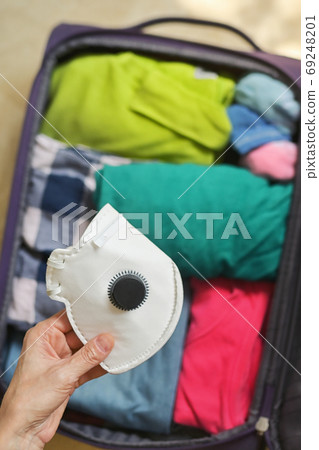 Travel Bag Packed With Clothes, And Medical Masks 69248201