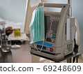 Surgical mask is placed on the medical device. With the patient in the room. 69248609