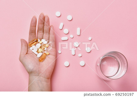 Assorted pharmaceutical medicine, Hand taking too much medication pills 69250197