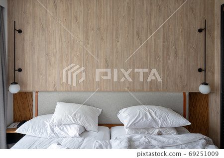 Headboard with lamp of bedroom with crumpled pillow and blanket Headboard with lamp of bedroom with crumpled pillow and blanket 69251009