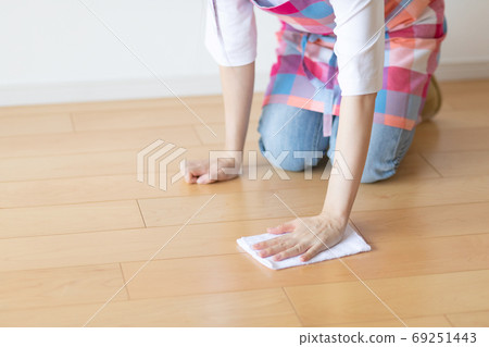 Woman cleaning the floor with a rag photo material Woman cleaning the floor with a rag photo material 69251443