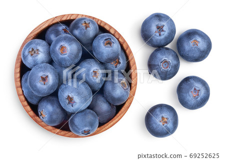 fresh ripe blueberry in wooden bowl isolated on white background with clipping path . Top view. Flat lay pattern fresh ripe blueberry in wooden bowl isolated on white background with clipping path . Top view. Flat lay pattern 69252625