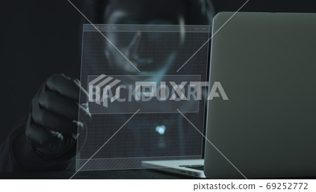 A hacker wearing black mask pulls BACKDOOR tab from a laptop. Hacking concept A hacker wearing black mask pulls BACKDOOR tab from a laptop. Hacking concept 69252772
