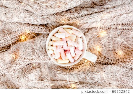 Cup of coffee wrapped in warm plaid. Autumn or Winter concept. Flat lay, top view Cup of coffee wrapped in warm plaid. Autumn or Winter concept. Flat lay, top view 69252842