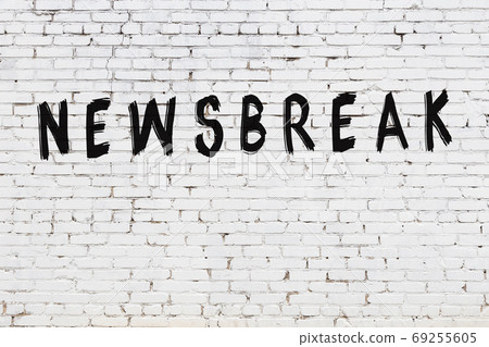 Inscription newsbreak painted on white brick wall 69255605