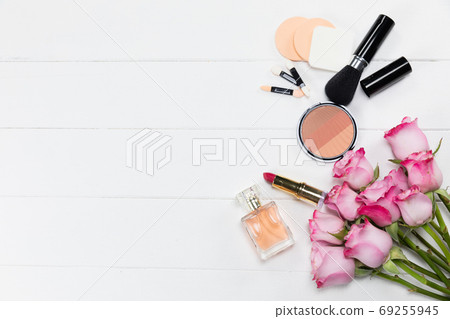 Make up view with pink flowers and perfume on white background Make up view with pink flowers and perfume on white background 69255945