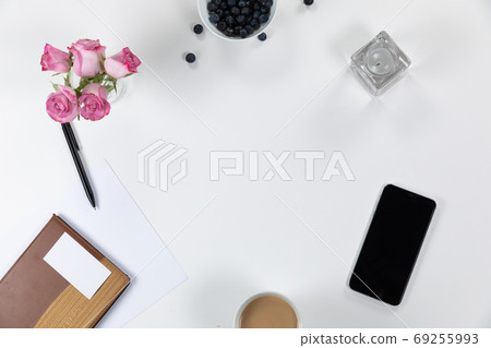 View of school supplies with flowers, phone and perfume on white background View of school supplies with flowers, phone and perfume on white background 69255993