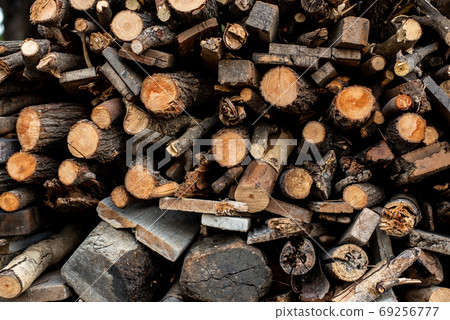 Piles of logs stacked waiting to make charcoal. Piles of logs stacked waiting to make charcoal. 69256777