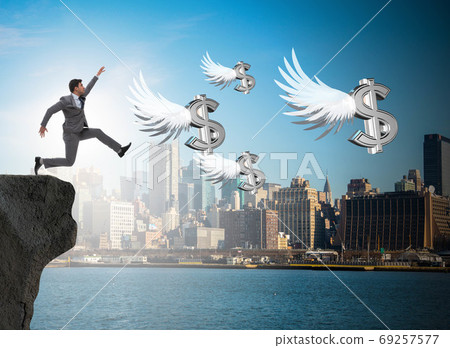 Businessman chasing angel dollars in business concept Businessman chasing angel dollars in business concept 69257577