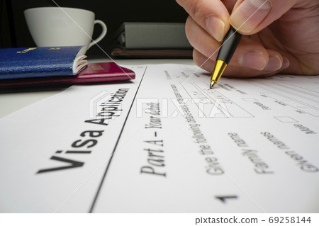 Applicant completing visa application form 69258144