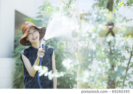 Female kitchen garden watering 69260395