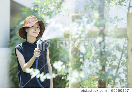 Female kitchen garden watering 69260397