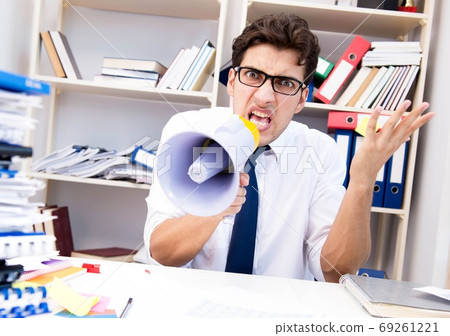 Busy frustrated businessman angry in the office Busy frustrated businessman angry in the office 69261221