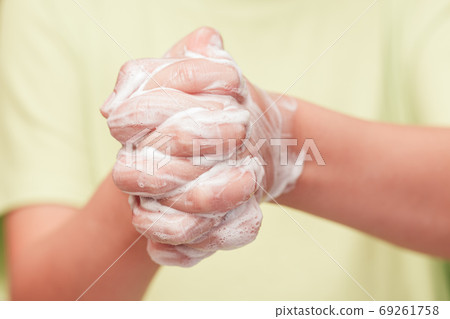 Front view on child hands with soap foam Front view on child hands with soap foam 69261758