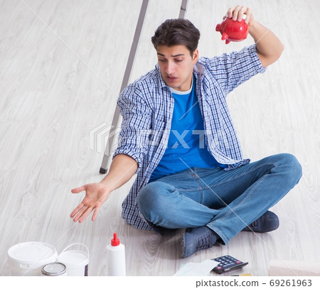 Young man overspending his budget in refurbishment project 69261963