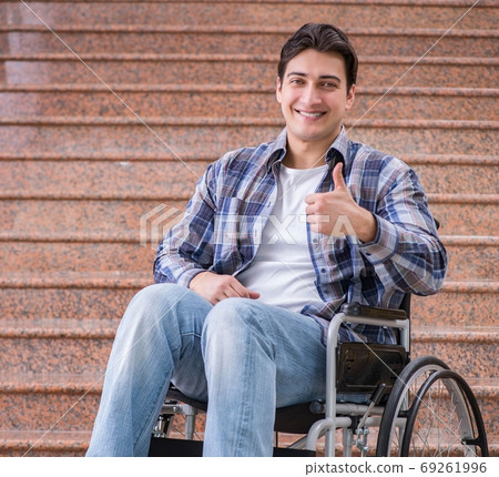 Disabled man on wheelchair having trouble with stairs Disabled man on wheelchair having trouble with stairs 69261996