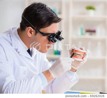 Young dentist working in the dentistry hospital Young dentist working in the dentistry hospital 69262026