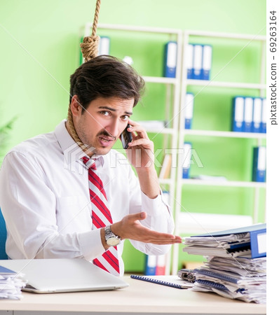 Despaired businessman thinking of suicide in the office 69263164