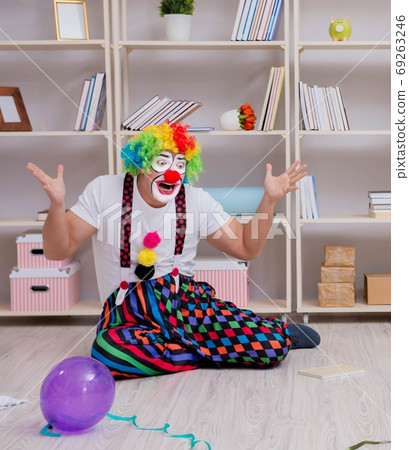 The drunk clown celebrating having a party at home 69263246