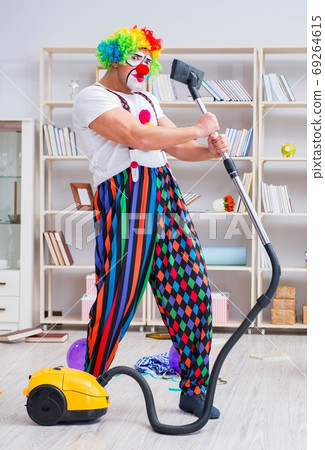 The funny clown doing cleaning at home 69264615