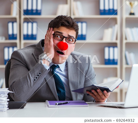 The clown businessman working in the office 69264932