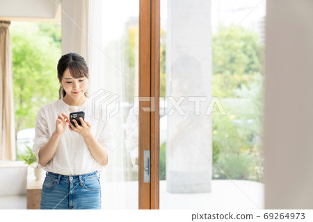 A woman using a smartphone A woman using a smartphone 69264973