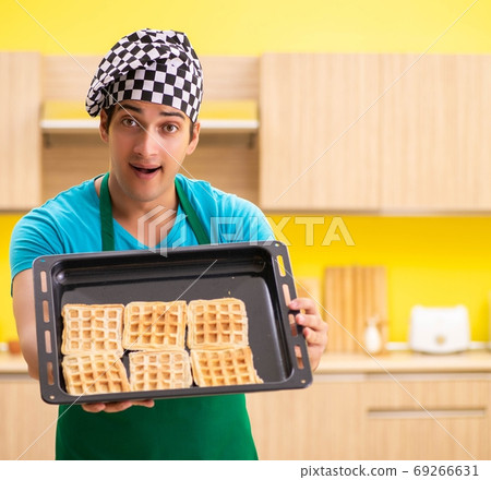Man cook preparing cake in kitchen at home 69266631