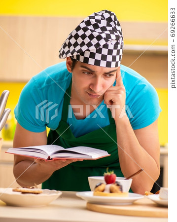 Man cook preparing cake in kitchen at home 69266633