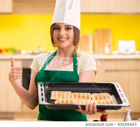 Young cook cooking cakes in the kitchen 69266663