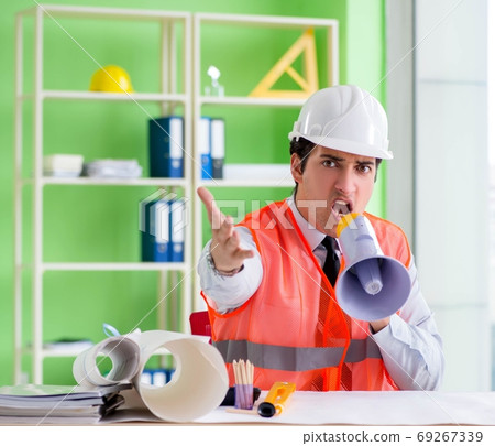Construction supervisor with loudspeaker sitting in the office 69267339