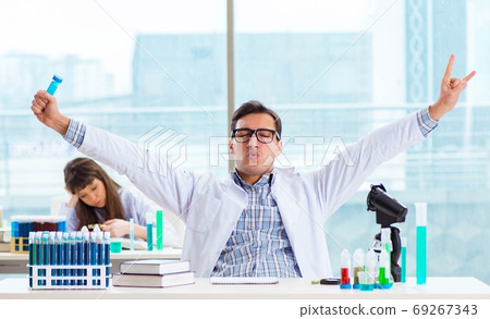 Two chemists working in lab experimenting Two chemists working in lab experimenting 69267343