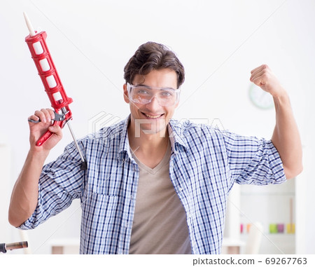 Young man in woodworking hobby concept 69267763