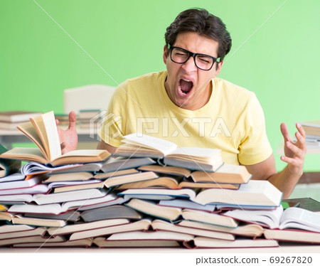 Student with too many books to read before exam Student with too many books to read before exam 69267820
