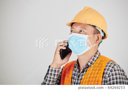 Construction worker calling on phone Construction worker calling on phone 69269253