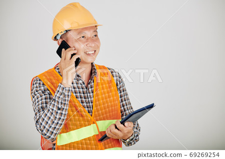 Contractor talking on phone Contractor talking on phone 69269254